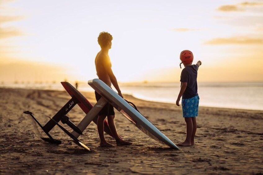 Two people on a beach with surfboards and a sunset in the background. 4