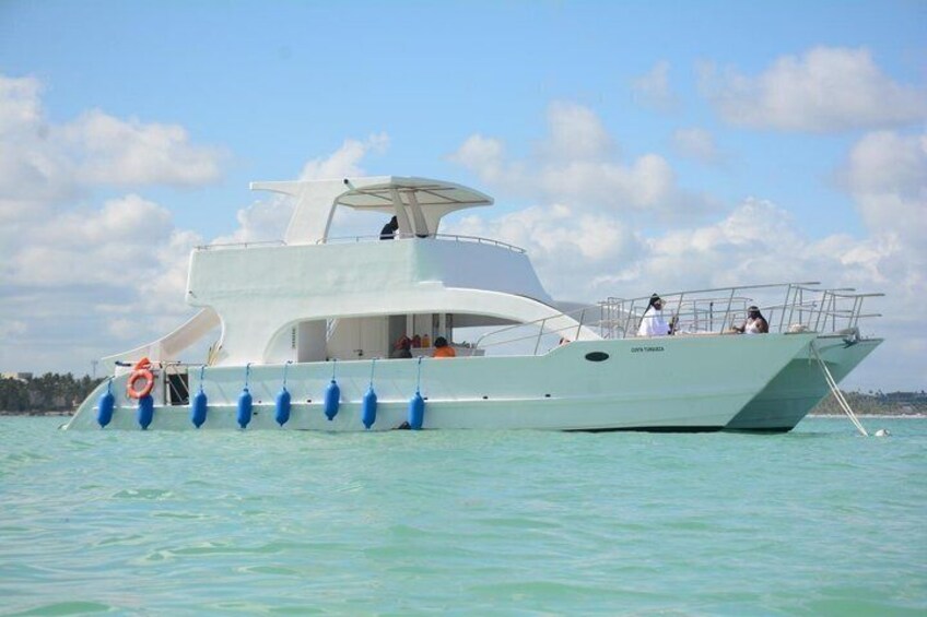 A large white yacht with blue buoys and a lifebuoy on the water. 1