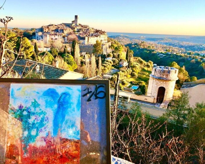 A hilltop town with a prominent tower and castle ruins. 1