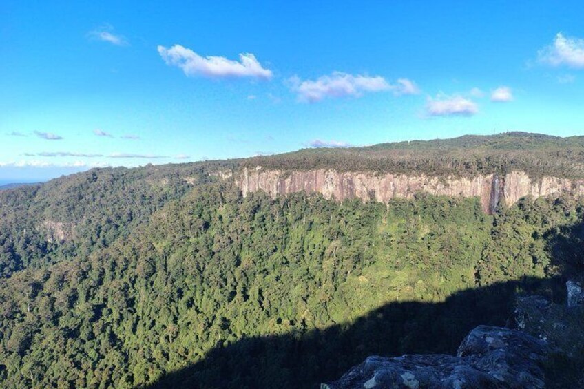 A forested mountain range with a clear sky. 3