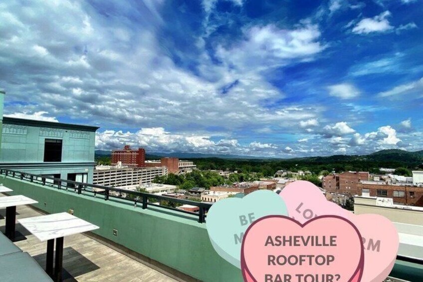A rooftop bar with a view of a cityscape and mountains in the distance. 4