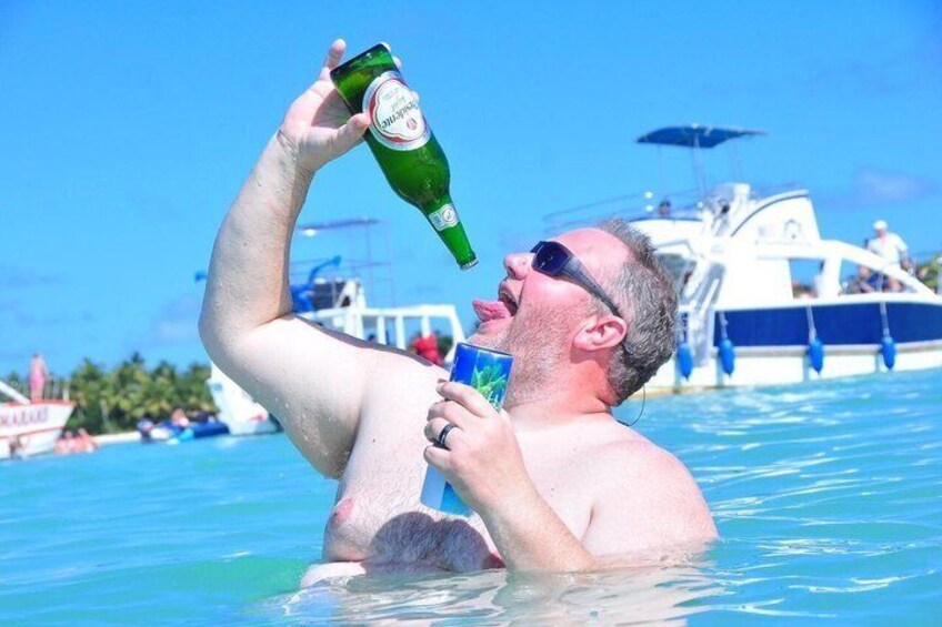 A person in a swimming pool holding a beer bottle. 5