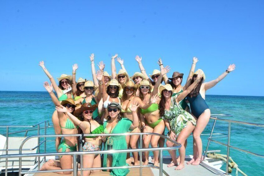 A group of people on a boat with the ocean in the background. 1