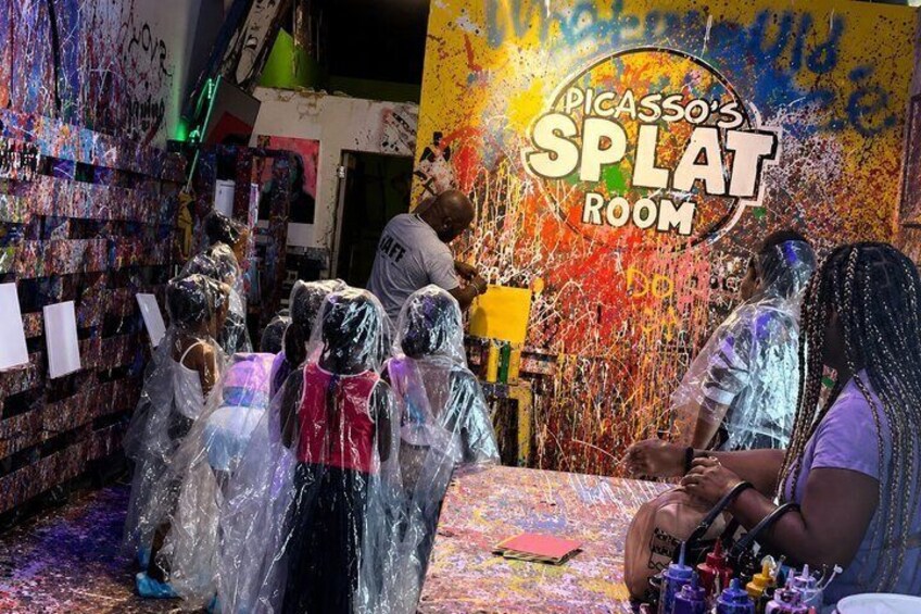 A room with a colorful mural and a sign reading 'Picasso's Splat Room.' 5