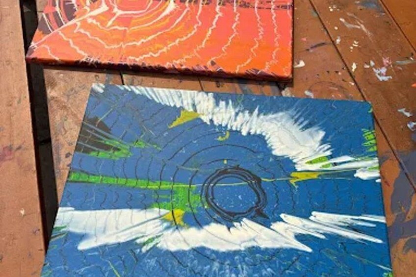 Two artworks on wooden boards with abstract designs. 2