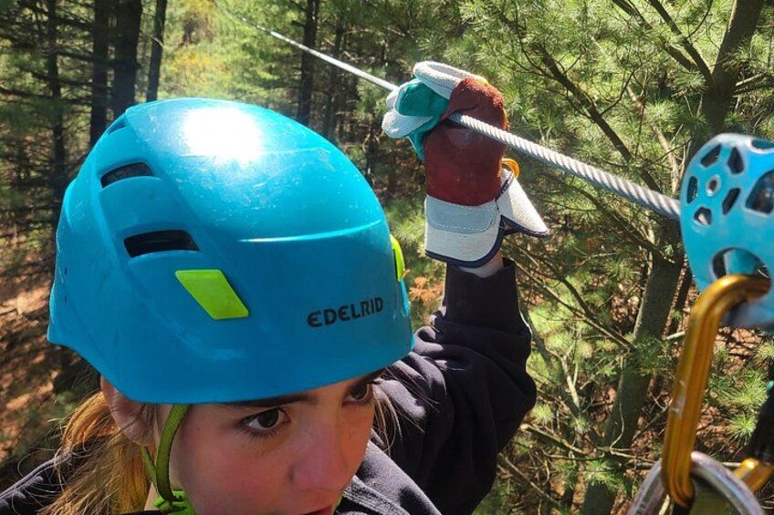 A person wearing a blue helmet and holding a rope. 4