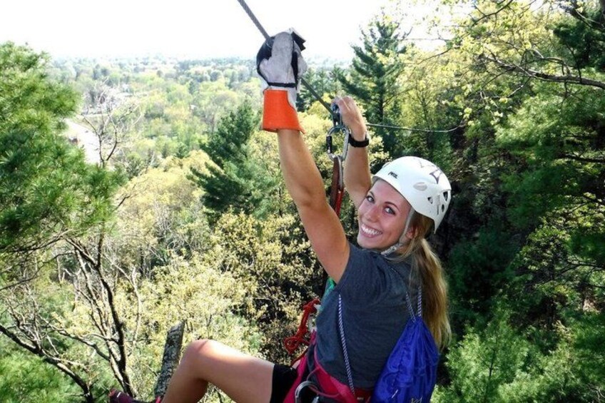 A person zip-lining through a forested area. 2