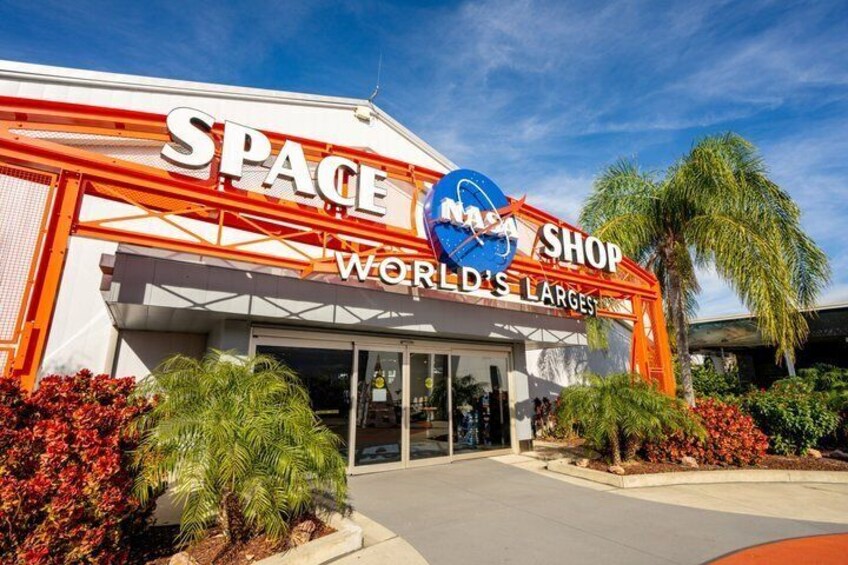 A building with a sign that reads 'SPACE SHOP WORLD'S LARGES' and a NASA logo. 4