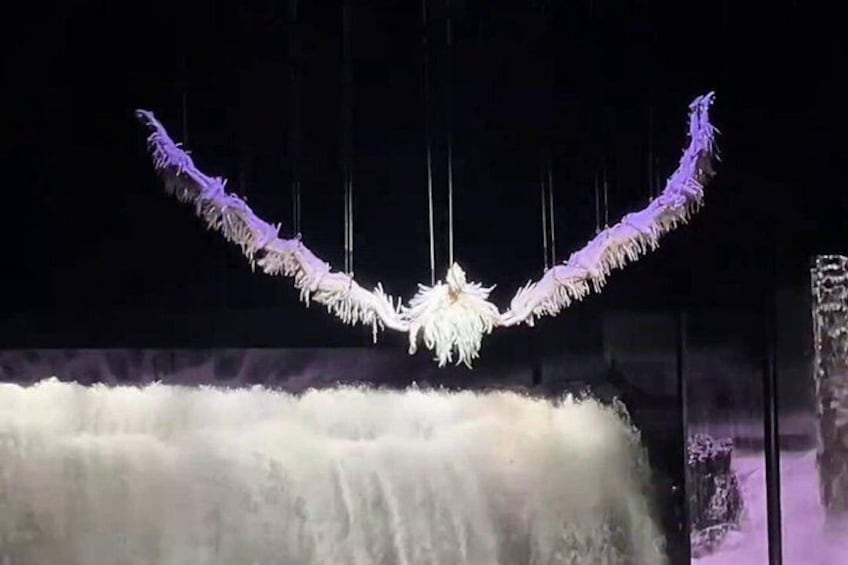 A waterfall with hanging decorations. 1
