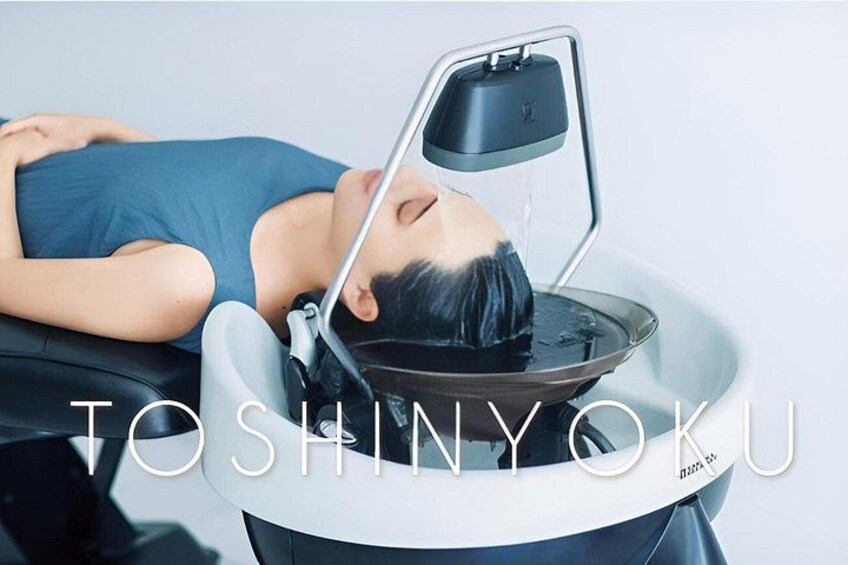 A person lying on a medical examination table with a device above them. 1