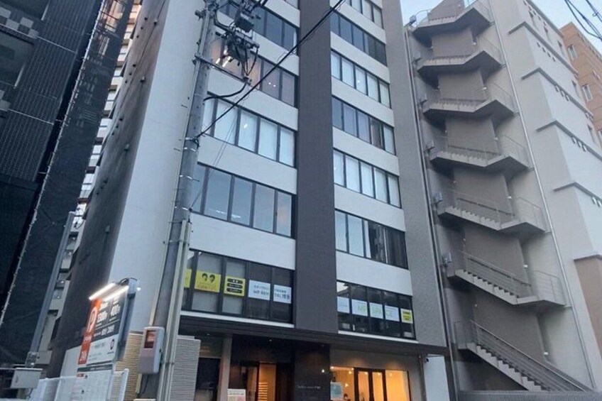 A multi-story building with a visible storefront at the ground level. 2