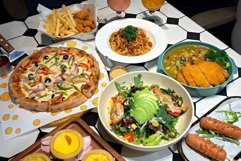 A table with various dishes including pizza, pasta, soup, salad, and bread. 4