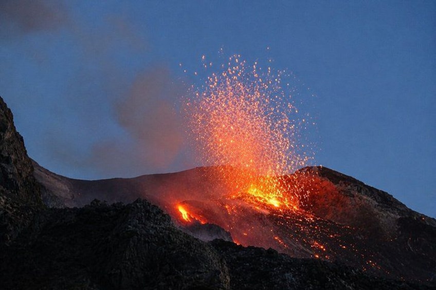 A volcanic eruption with lava flowing down the side of a mountain. 4