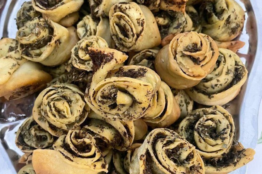 A bowl of cinnamon rolls with visible cinnamon and sugar. 3