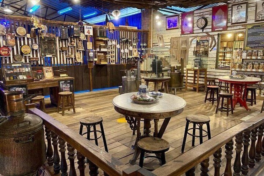 A vintage-themed bar with wooden furniture, a round table, and various decorative items on the walls. 5