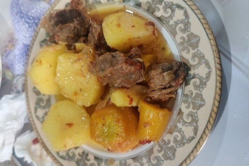 A plate of food with potatoes and meat. 2