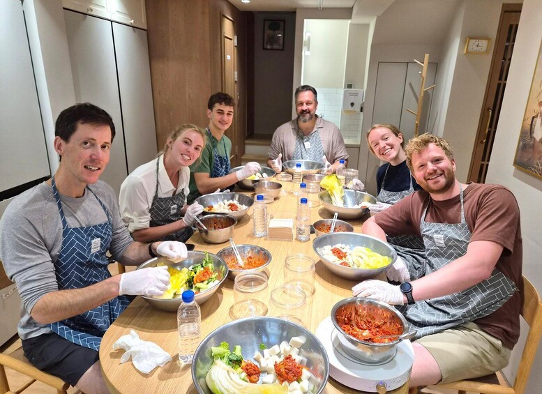A group of people preparing food in a kitchen. 5