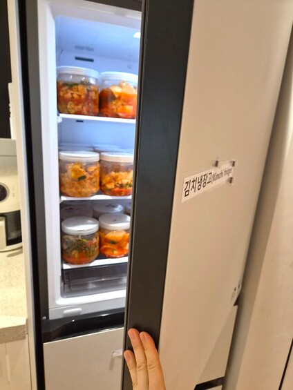 A refrigerator with multiple containers of kimchi. 5