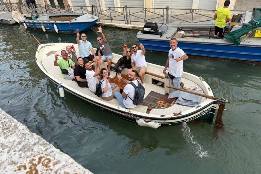 A group of people on a small boat in a canal. 2