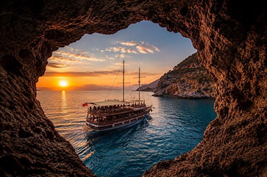 A boat with passengers, a sunset, and a rocky coastline. 3