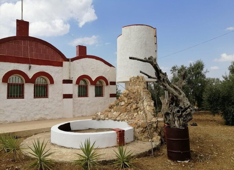 A building with red arches and a white cylindrical structure. 4