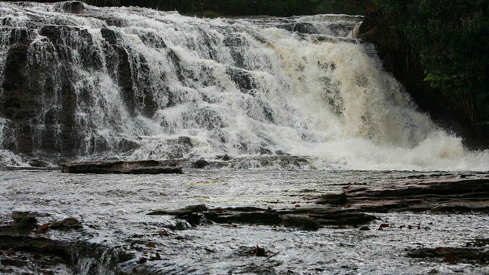 A powerful waterfall cascading over rocks. 3