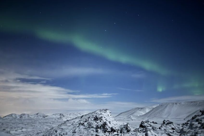A snowy mountain landscape with the aurora borealis. 4