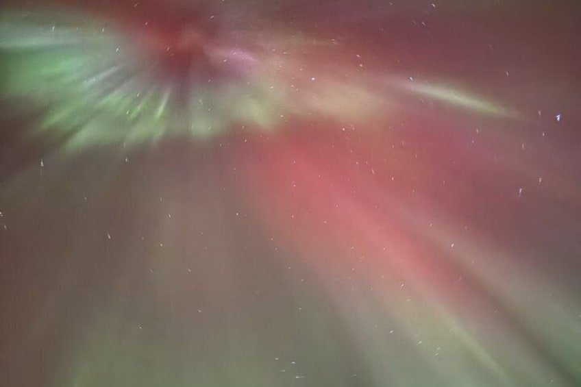 A starry night sky with visible aurora borealis. 5