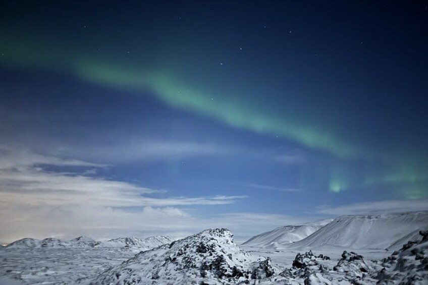 A snowy mountain landscape with the aurora borealis. 4
