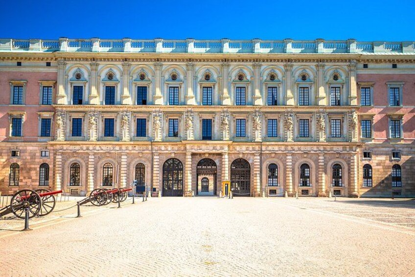A historic building with a large courtyard, classical architecture, and a carriage in the foreground. 2
