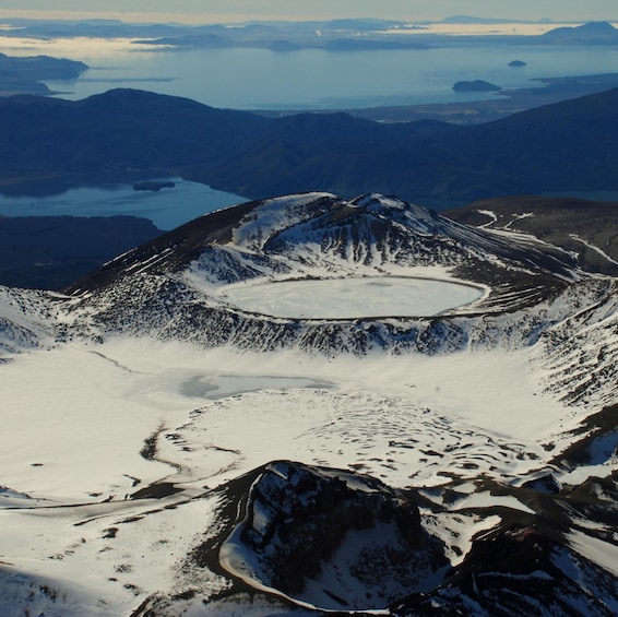 A snow-covered mountain with a crater lake. 2