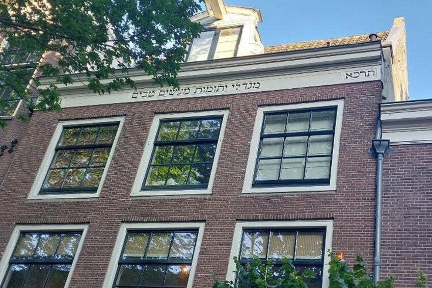 A building with multiple windows and a brick facade. 3