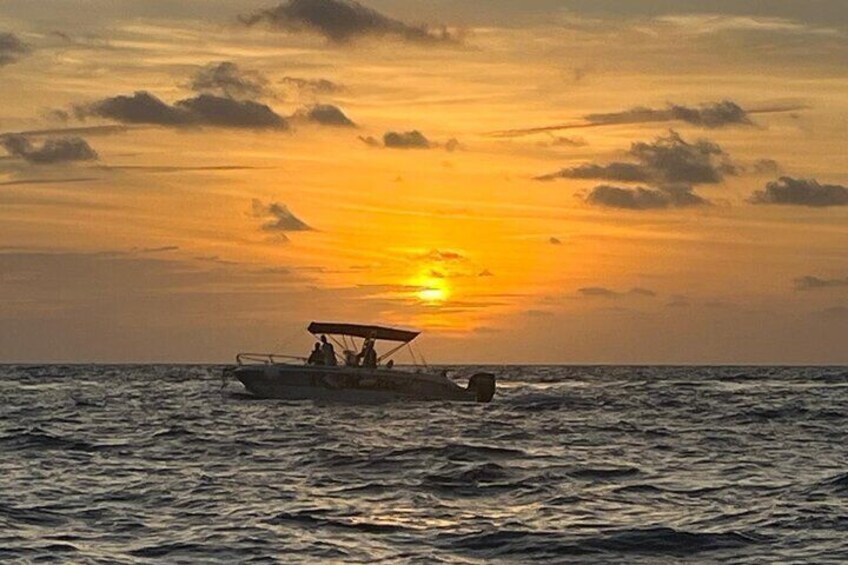 A boat on the ocean during sunset. 5