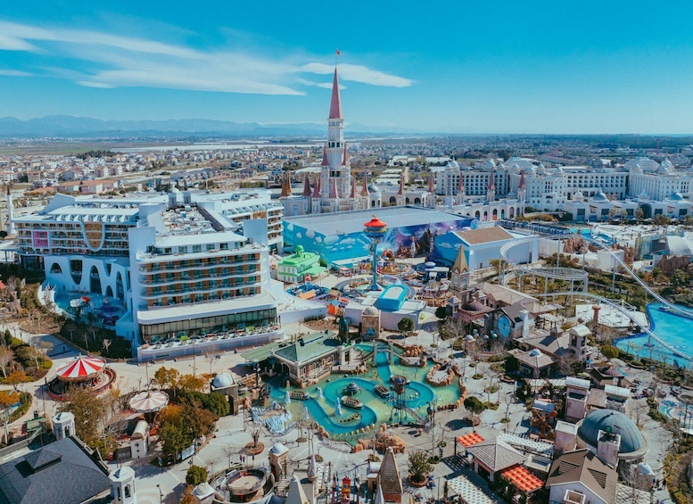 A theme park with a large water park, a hotel, and a prominent tower. 5