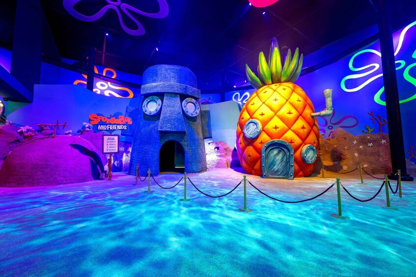 A themed exhibit with a large pineapple and a blue structure, possibly a submarine, with a sign reading 'SpongeBob and Friends.' 4