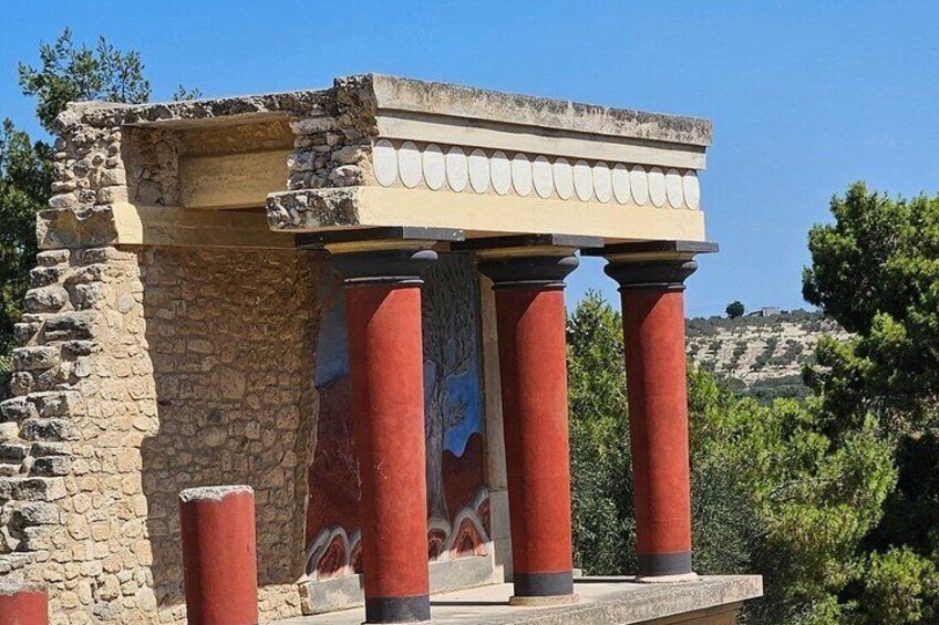 An ancient structure with columns and a painted frieze. 3