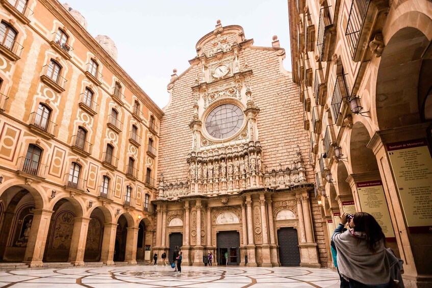 A historic building with intricate carvings and a large circular window. 3