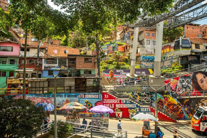 A vibrant street scene with colorful murals, a cable car, and a bustling urban environment. 1