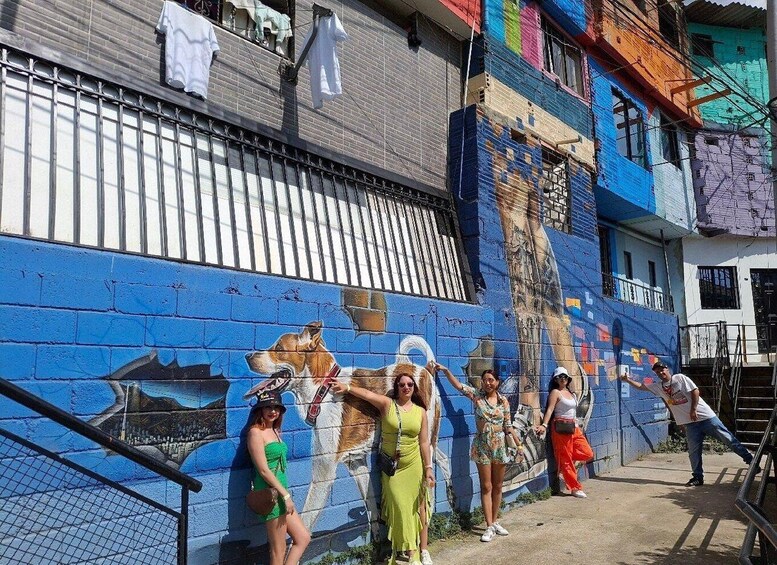 A mural on a building with a dog and a person. 5
