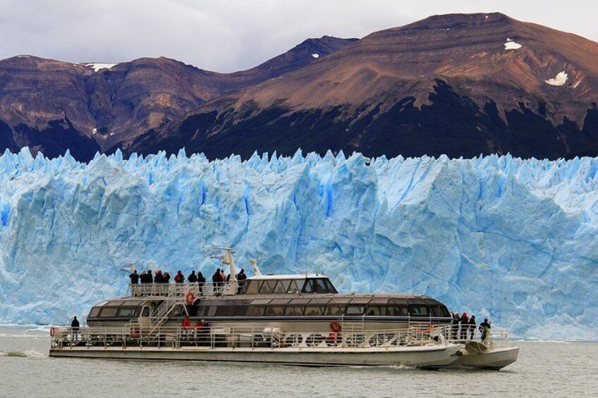 A boat with passengers near a glacier. 4