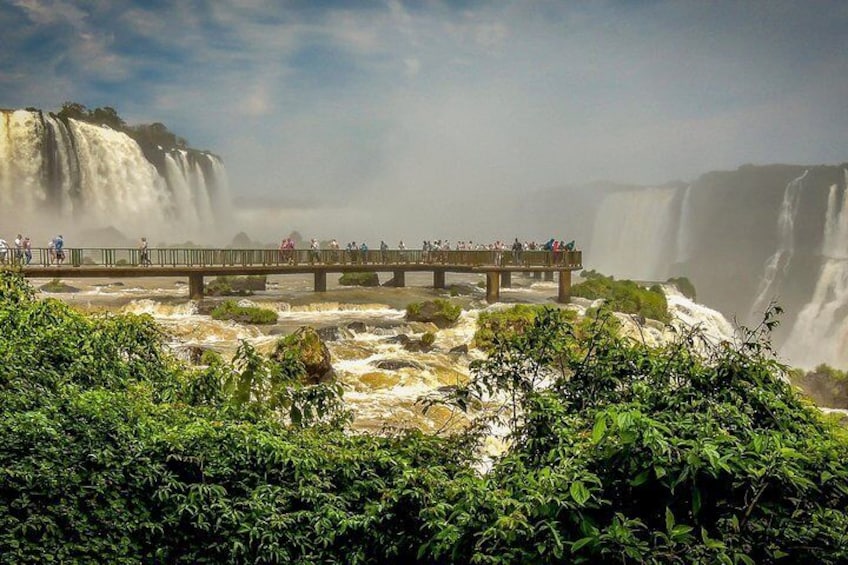 A waterfall, a bridge, and lush greenery. 5