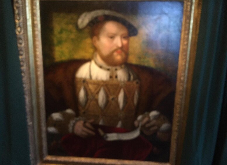 A portrait of a person in historical attire, framed in an ornate picture frame. 5