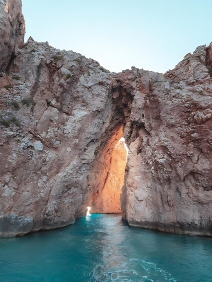 A natural rock formation with a water body at its base. 2