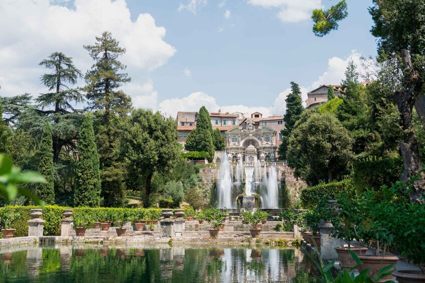 A serene garden with a central fountain, surrounded by lush greenery and classical architecture. 1