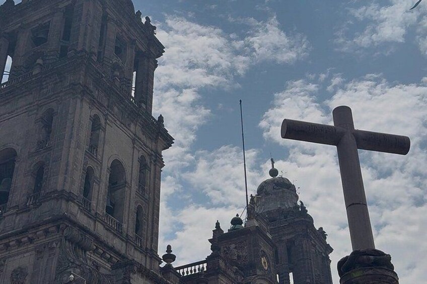 A historic building with a large bell tower and a cross. 5