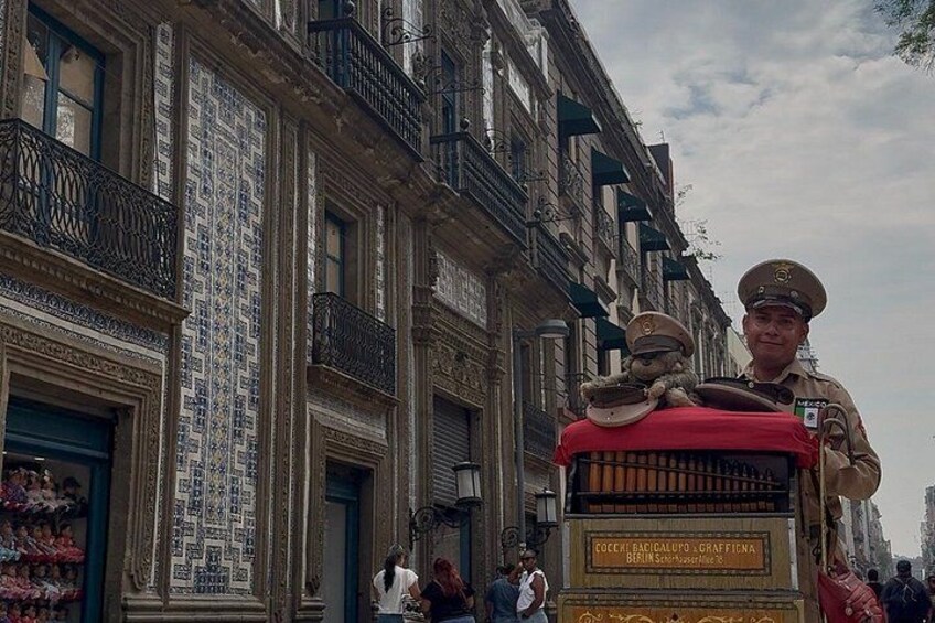 A street scene with a horse-drawn carriage, a building with ornate balconies, and pedestrians. 4