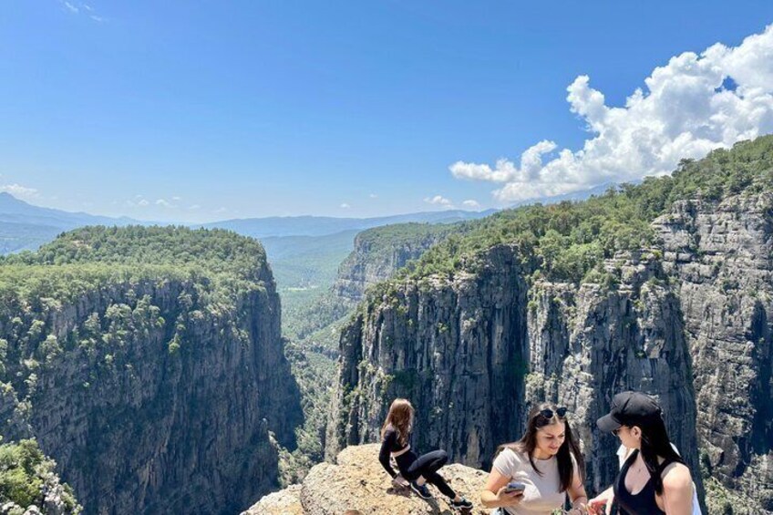 A mountainous landscape with steep cliffs and a valley. 1