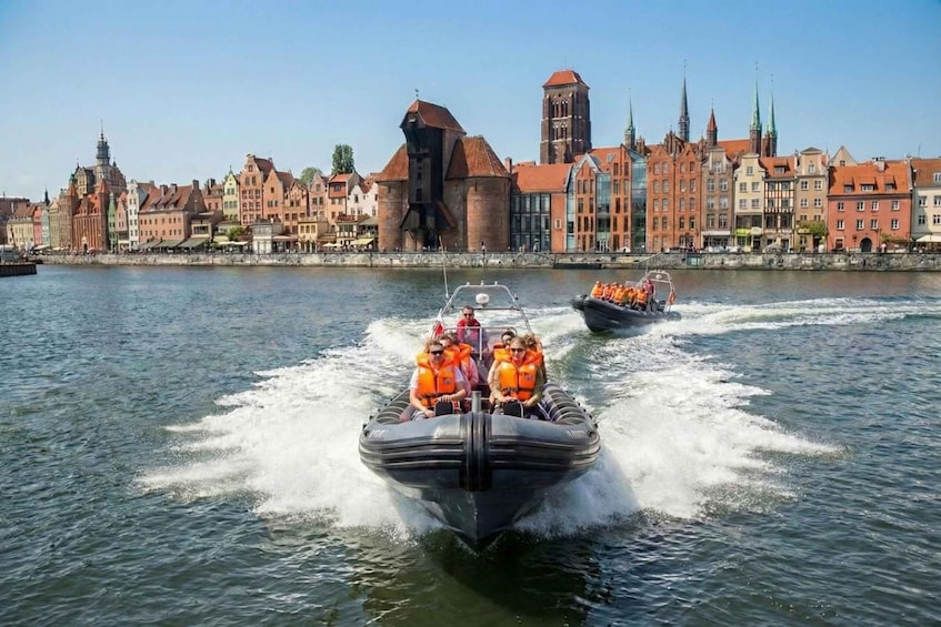 A boat speeding across a river with a historic cityscape in the background. 5