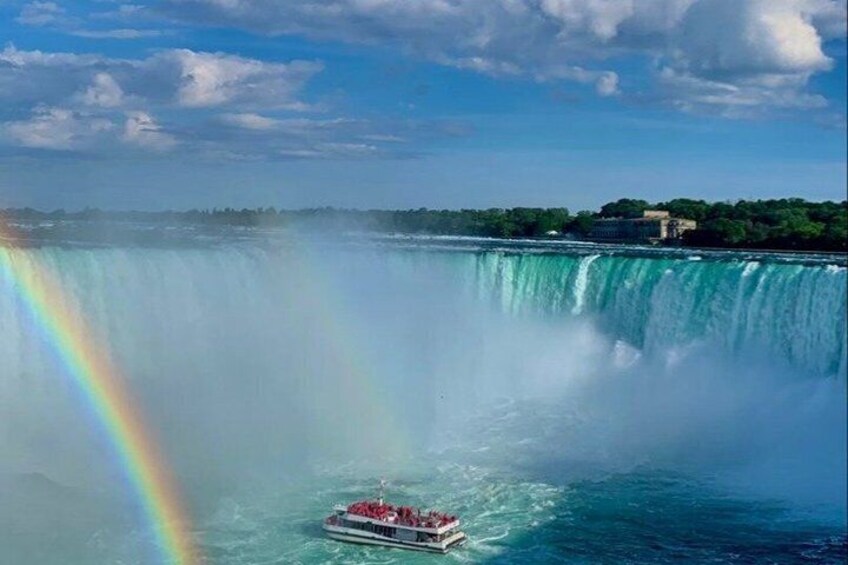 A boat on a waterfall with a rainbow. 5