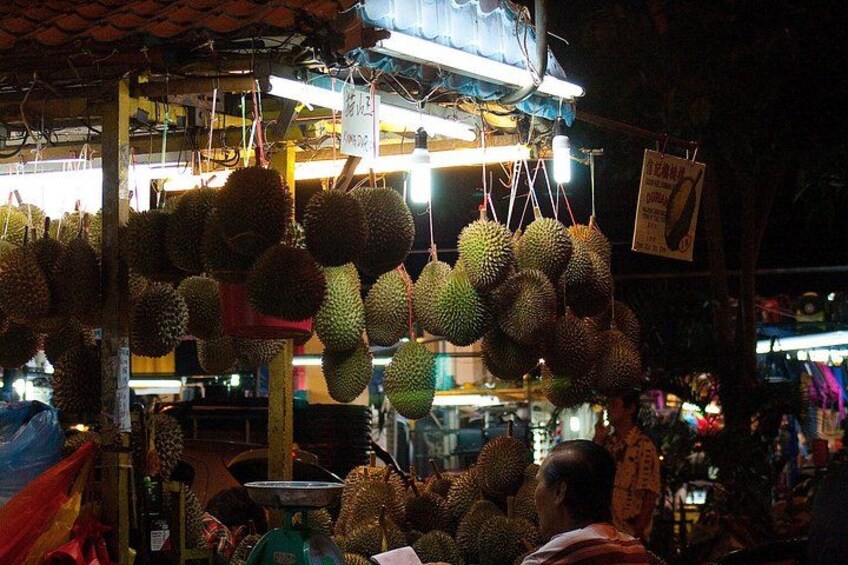 Durians hanging at a market stall. 2